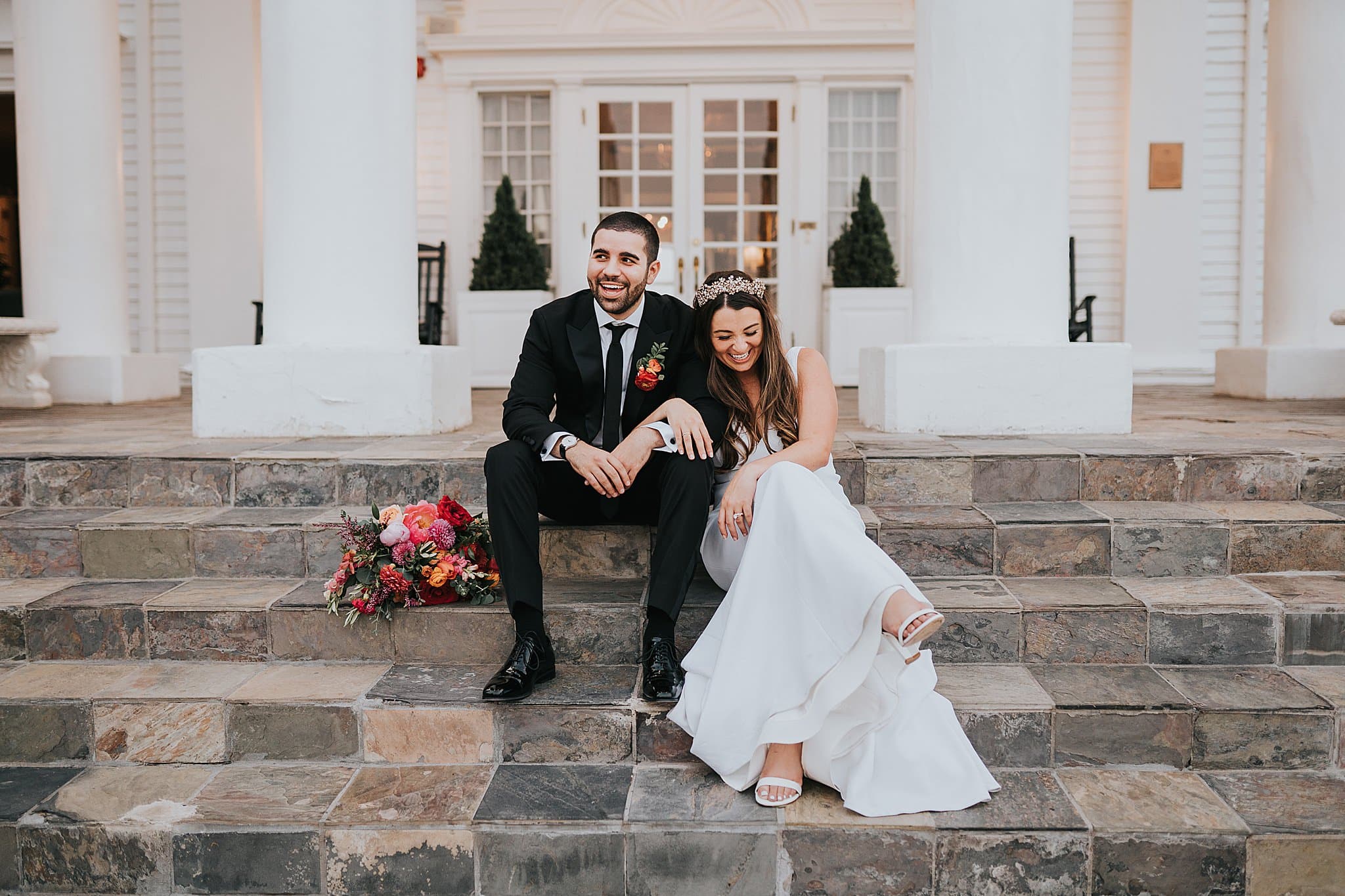 couple laughing on steps of Manor House Morrison, CO