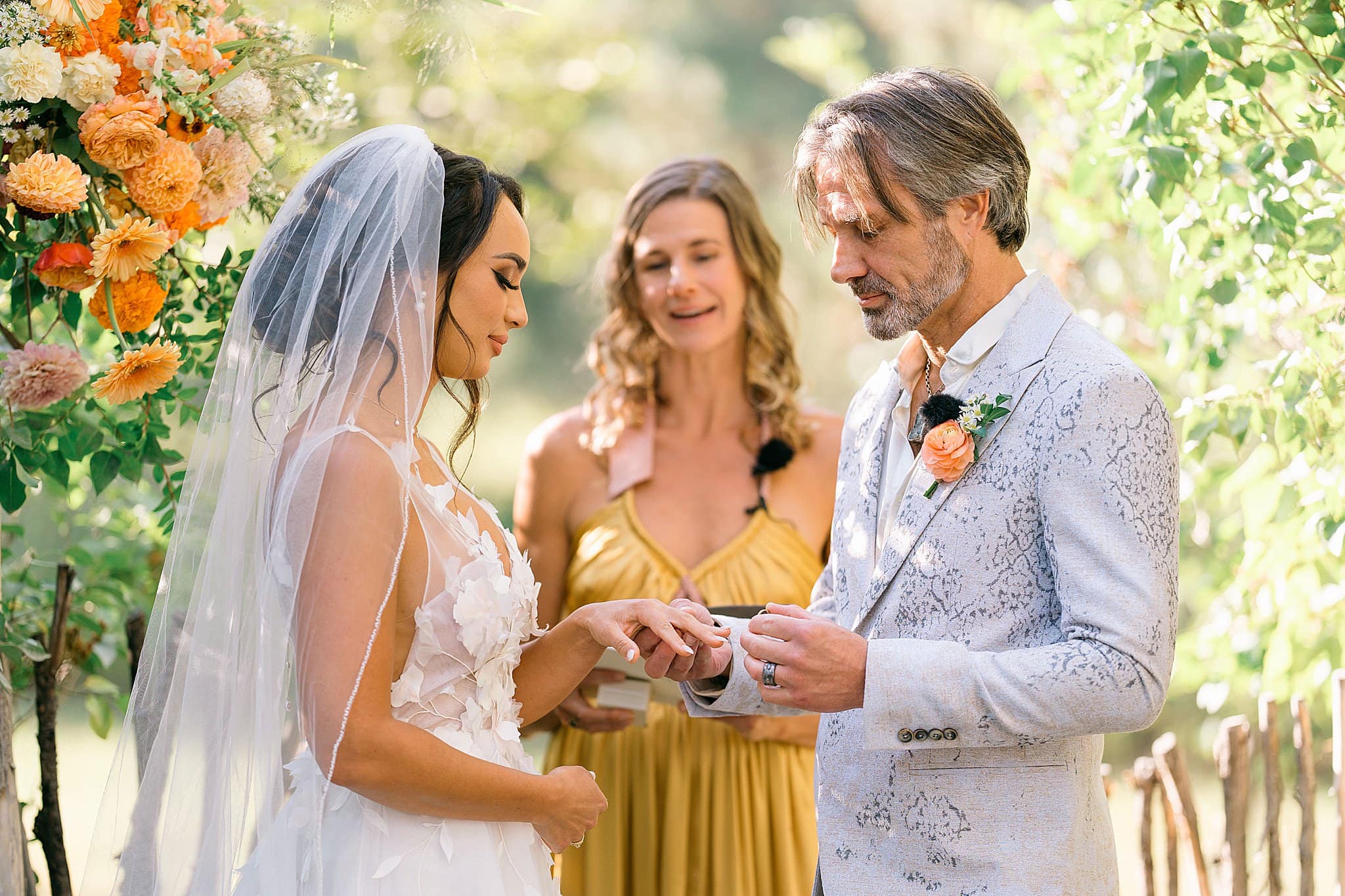 a bride and groom exchanging rings, wondering if they should tip wedding vendors